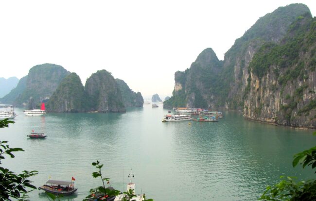 Ha Long Bay limestone islands, northern Vietnam Limestone karst islands and boats in Ha Long Bay, northern Vietnam